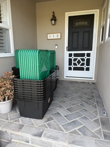 Stack of 805 Totes moving totes delivered to a Ventura County front porch