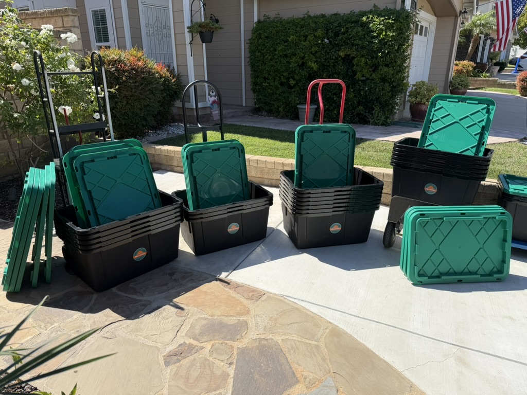 Rows of 805 Totes moving totes and hand trucks staged on a driveway