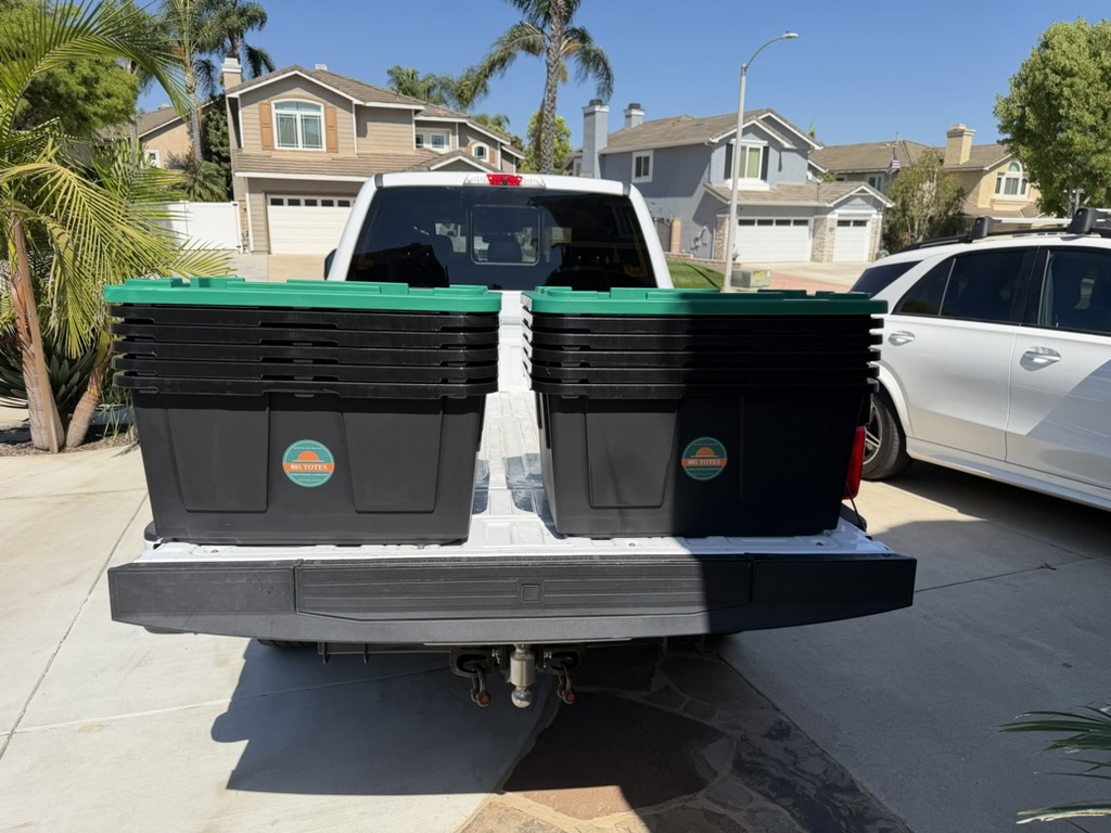 Two stacks of branded 805 Totes on a truck tailgate before delivery